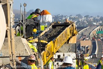 Caltrans crew using heavy equipment for the construction of a new median barrier as part of the US 101 Hospital Curve Rehabilitation Project on March 28, 2026.