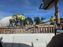Caltrans crew pouring concrete into the median barrier forms for building the new median barrier as part of the US 101 Hospital Curve Rehabilitation Project on March 29, 2026.