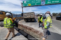 Four people work on the installation of new drainage infrastructure on on U.S. 101 in San Francisco on August 22, 2026.