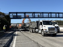 Caltrans crew using an excavator to remove old pavement as onlookers stand on the pedestrian bridge on northbound U.S. 101 Bayshore Freeway (Hospital Curve) in San Francisco on September 5, 2026.