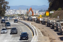 Cars traveling on southbound US-101 as Caltrans trucks ligned up next to removed concrete pavement on northbound U.S. 101 Bayshore Freeway (Hospital Curve) in San Francisco on September 5, 2026.