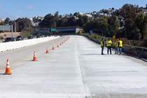 Caltrans workers on the newly poured concrete pavement on northbound U.S. 101 Bayshore Freeway (Hospital Curve) in San Francisco on September 6, 2026.