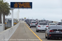Vehicles traveling on the eastern span of the Bay Bridge pass  a sign alerting drivers to the closure of northbound US-101 in San Francisco.