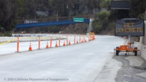 A sign alerts workers to wet concrete while traffic cones line the repaved lanes of northbound US-101 near Hospital Curve in San Francisco on Sunday, September 20, 2026.