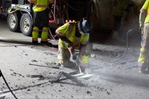 Crew members work on the removal of the old roadway material on southbound US-101 during the night of October 16, 2026.