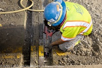 Crew member works on the removal of the old roadway material on southbound US-101 during the night of October 16, 2026.