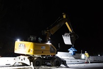 Heavy equipment is used to place temporary barriers during the closure of southbound US-101 during the night of October 16, 2026.