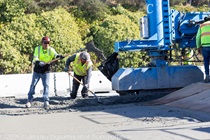 Crew members install new roadway material as part of the roadway rehabilitation project on southbound US-101 near Hospital Curve on Saturday, October 17, 2026.