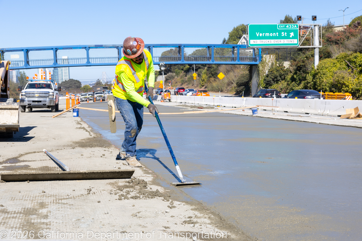 A crewmember smooths concrete during the roadway rehabilitation project on southbound US-101 near Vermont Street on Saturday, October 17, 2026.