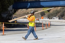 A crew member working during the closure of southbound US-101 near Hospital Curve on Sunday, October 18, 2026.