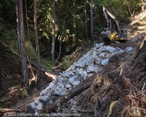 SR-84 storm damage repair of landslide (slipout) at PM 17.9 near Woodside, rock slope protection installation, geotextile netting installation