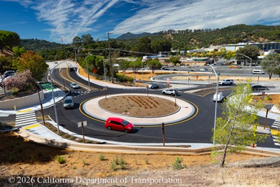 Cars travelling around the new roundabout at Manuel T. Freitas Parkway/US-101 interchange.