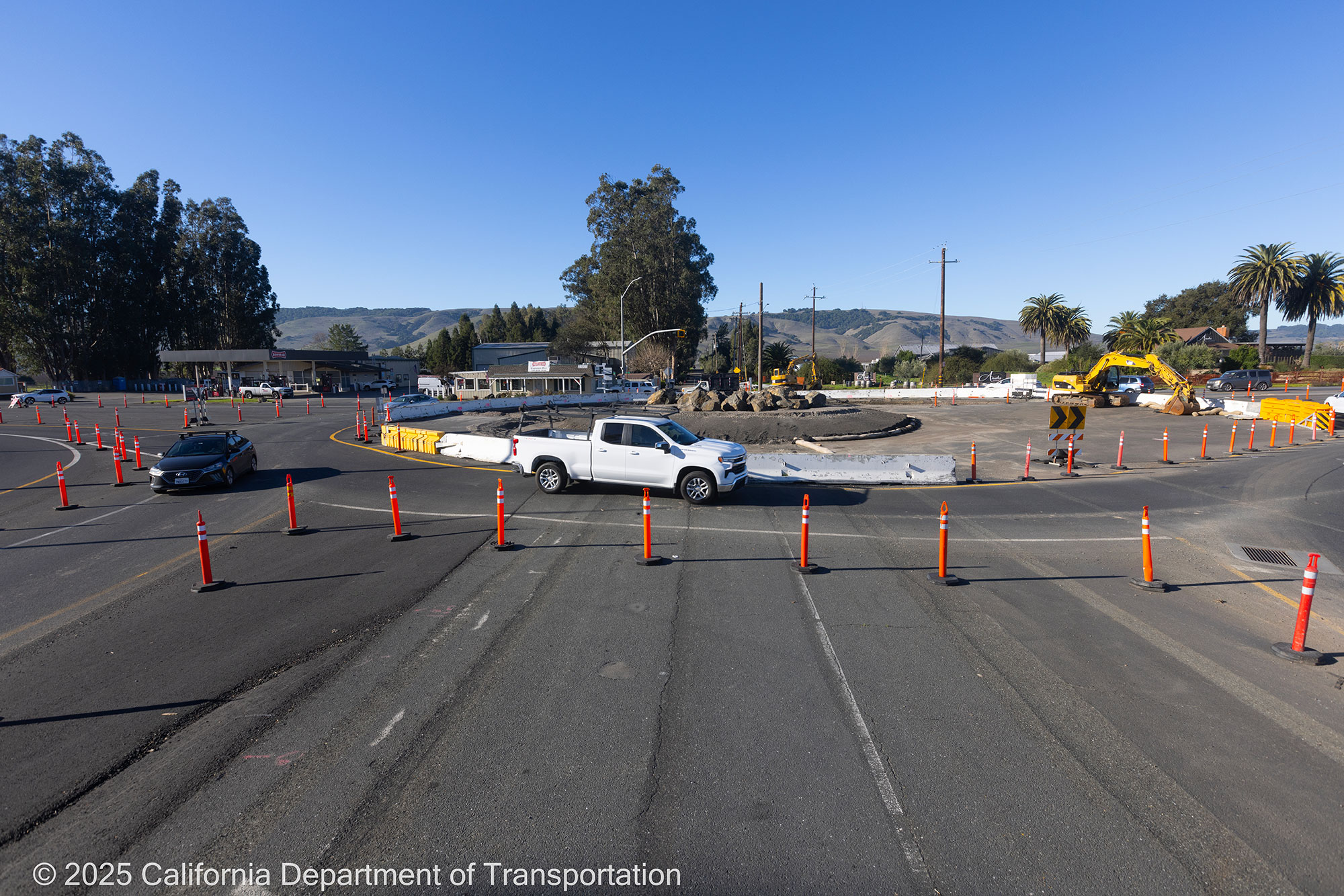 Cars traveling around the unfinished roundabout as Caltrans crew works on the roundabout project at Manuel T. Freitas Parkway/US-101 interchange.