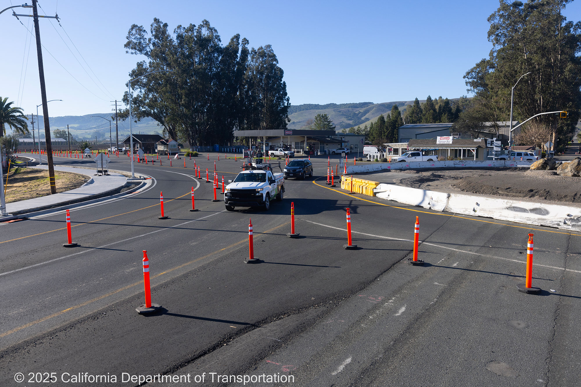 Cars traveling around the unfinished roundabout as Caltrans crew works on the roundabout project at Manuel T. Freitas Parkway/US-101 interchange.