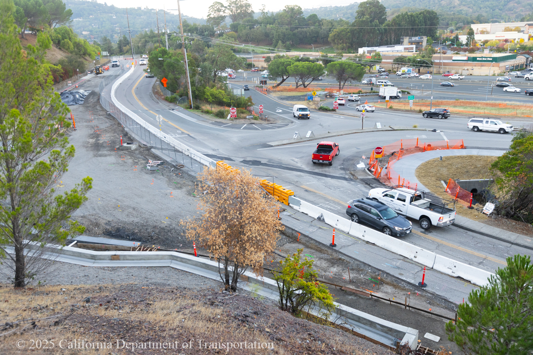 Cars traveling around the unfinished roundabout as Caltrans crew works on the roundabout project at Manuel T. Freitas Parkway/US-101 interchange.