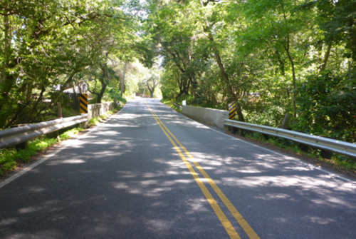 The a bridge with concrete side barriers crosses West Union Creek on State Route 84 in San Mateo County.