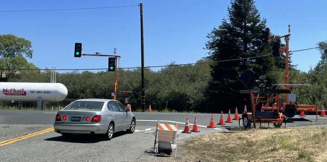 Car at an intersection as Caltrans works on the Lagunitas Creek Bridge Replacement Project,