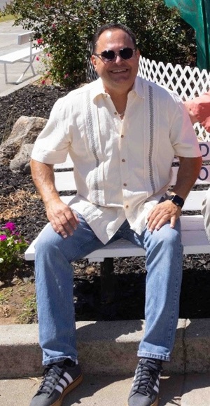 Caltrans' Maintenance Manager Bob Ferronato sitting on a chair, retires after 34 years of state service.