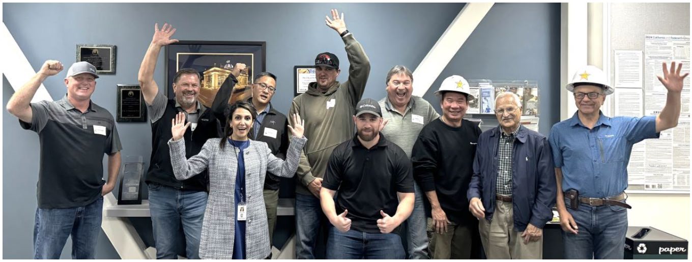 Photo of the Woodside Improvements Project team celebrates their win of the John L. Martin Partnering Project of the Year Award.