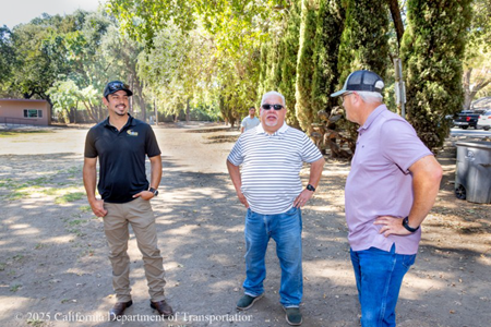 Three men converse at the worker appreciation event for the Solano I-80 Express Lanes project.