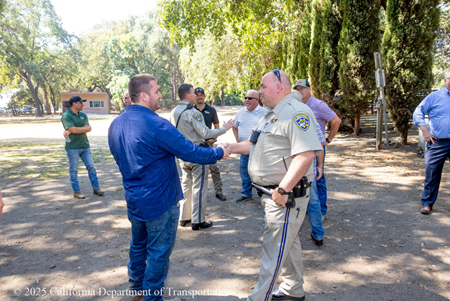 Workers and CHP officers shake hands at the worker appreciation event for the Solano I-80 Express Lanes project.