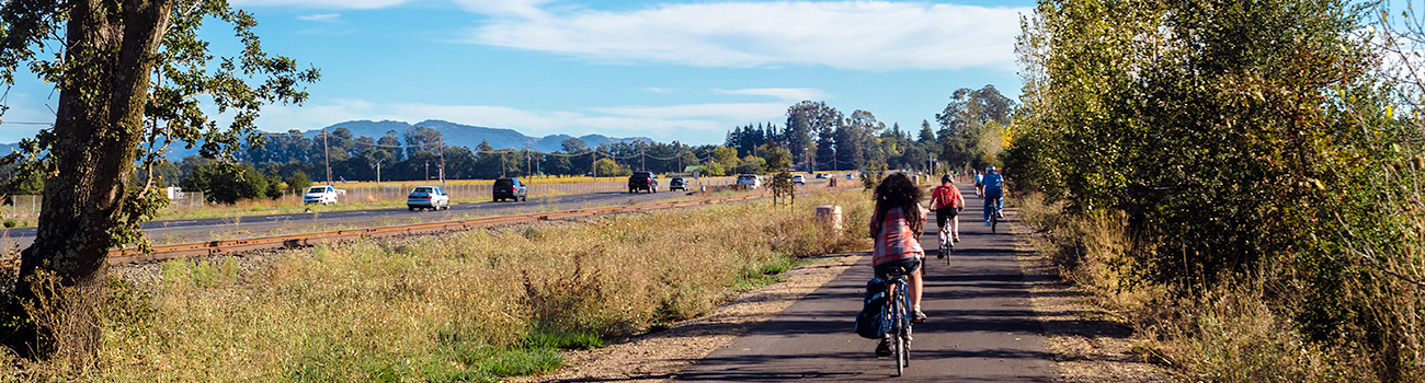 Photo of bicyclists on a bike path in a rural setting.