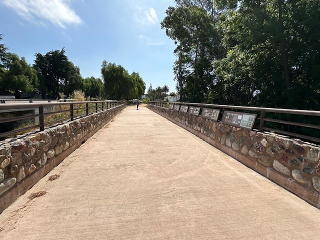 Photo of walkway of bridge showing interpretive panels on the side