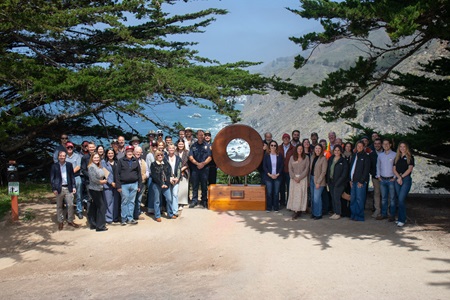 Event attendees pose alongside "Portal to Big Sur" at Ragged Point Inn