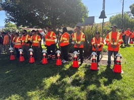 Staff behind cones as part of Workers Memorial