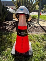 Traffic cone with name of fallen worker Kyle Truesdale and Caltrans helmet