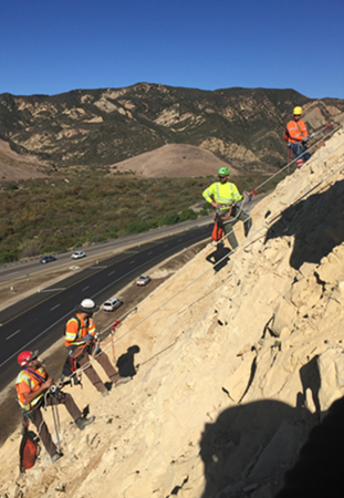 Workers scaling cliff off highway 101.