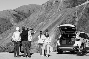 Caltrans staff and media observing and discussing the Regent's slide area