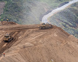 Photo showing heavy equipment and Caltrans staff on project site.