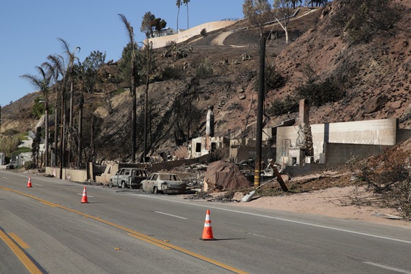 Orange cones on fire damaged road
