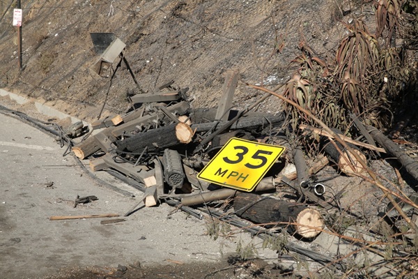 Fallen 35mph sign side of fire damaged road
