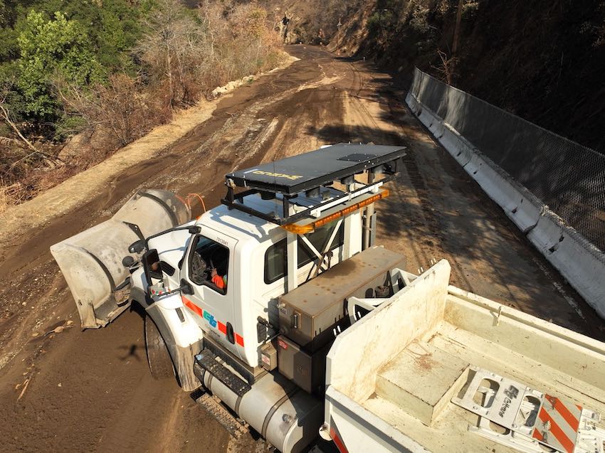 Topanga Canyon SR 27 Caltrans truck with a plow removing mud from the roadway. The picture is taken from above.