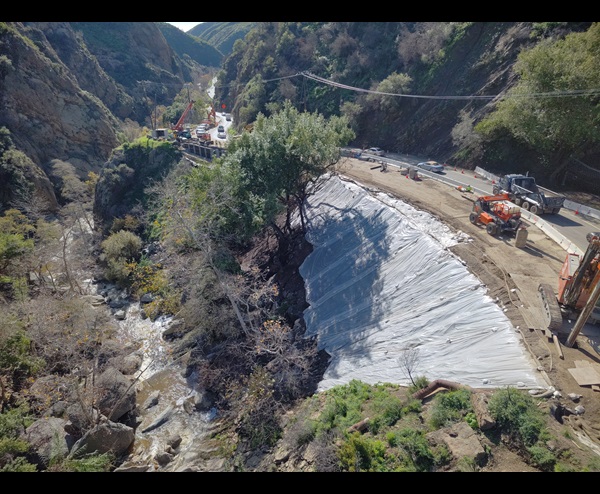 A drone shot of the emergency work zone on Topanga Canyon Boulevard with construction crews and equipment is shown Jan. 8, 2026.