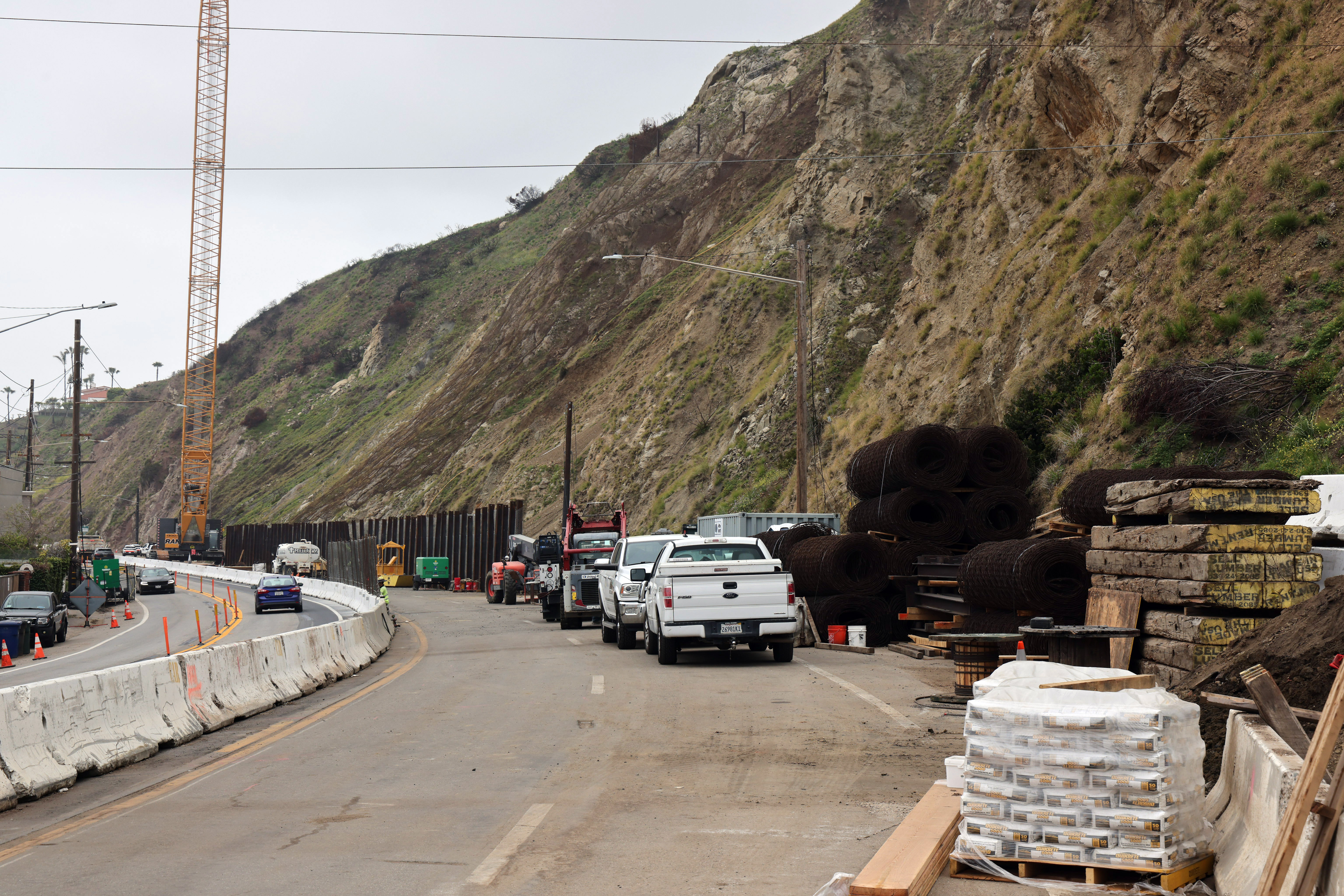 View of Pacific Coast Highway repairs and construction materials on right shoulder.