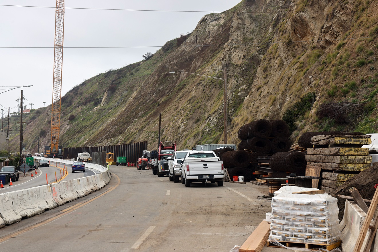 View of Pacific Coast Highway repairs and construction materials on right shoulder.