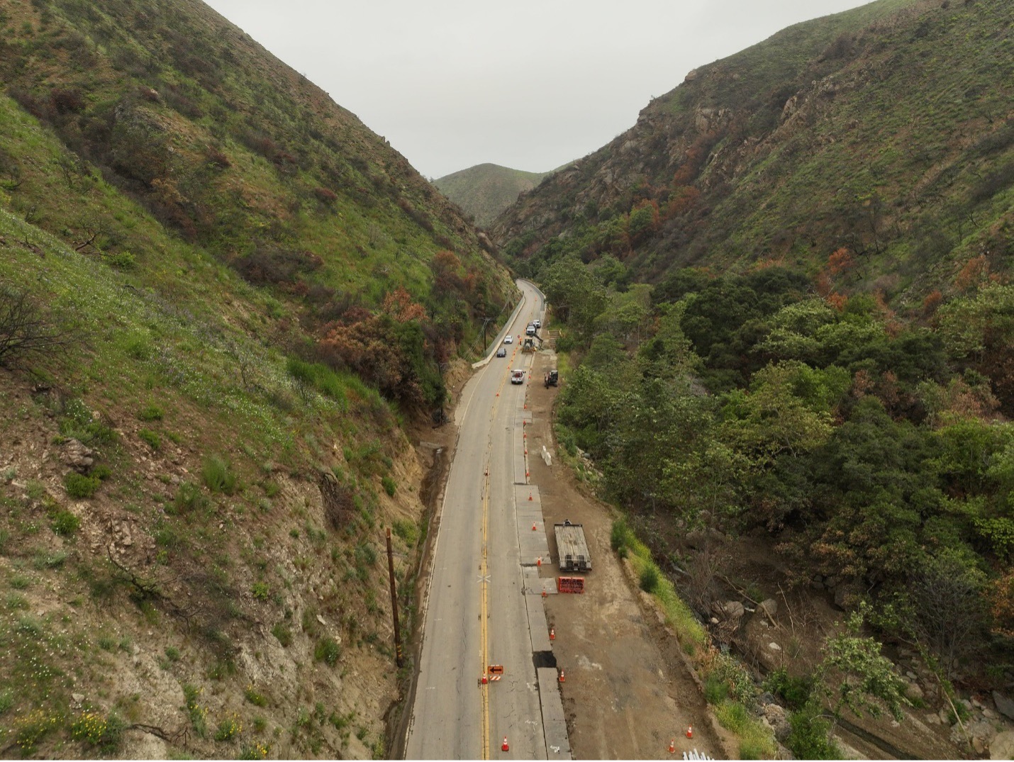 Cars driving on Topanga Canyon Boulevard/State Route 27 with traffic cones and signs seen marking a closed lane segment.