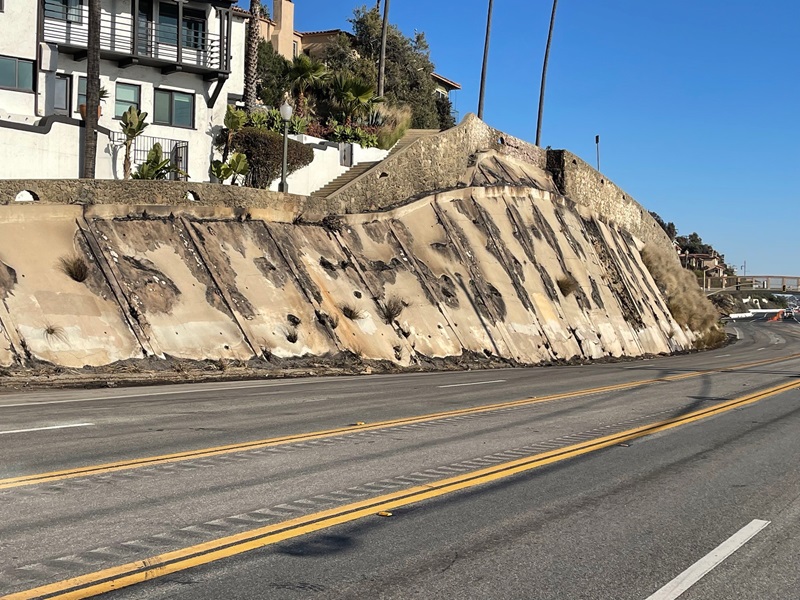 The damaged retaining wall near Porto Marina Way is shown in spring 2026.