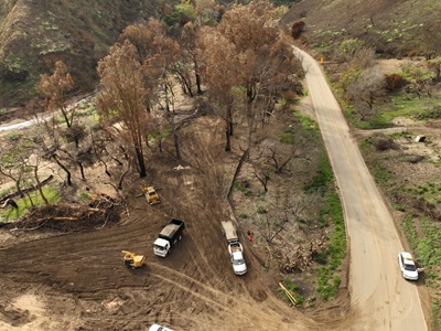 Photo showing cleared road from cleanup and repair progress along SR-27