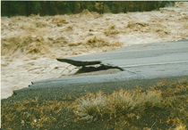 The jagged edge of pavement on U.S. 395 is left hanging after flood waters washed through the area on January 2, 1997.