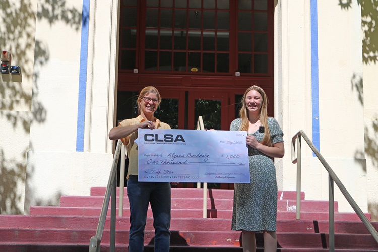 Caltrans Senior Transportation Surveyor Sereyna Cagle presents Bishop Union High School senior Alyssa Buchholz with a $1,000 check for her Trig-Star competition win.
