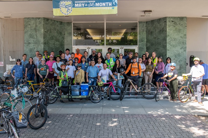 Bicyclists posing for a group photo