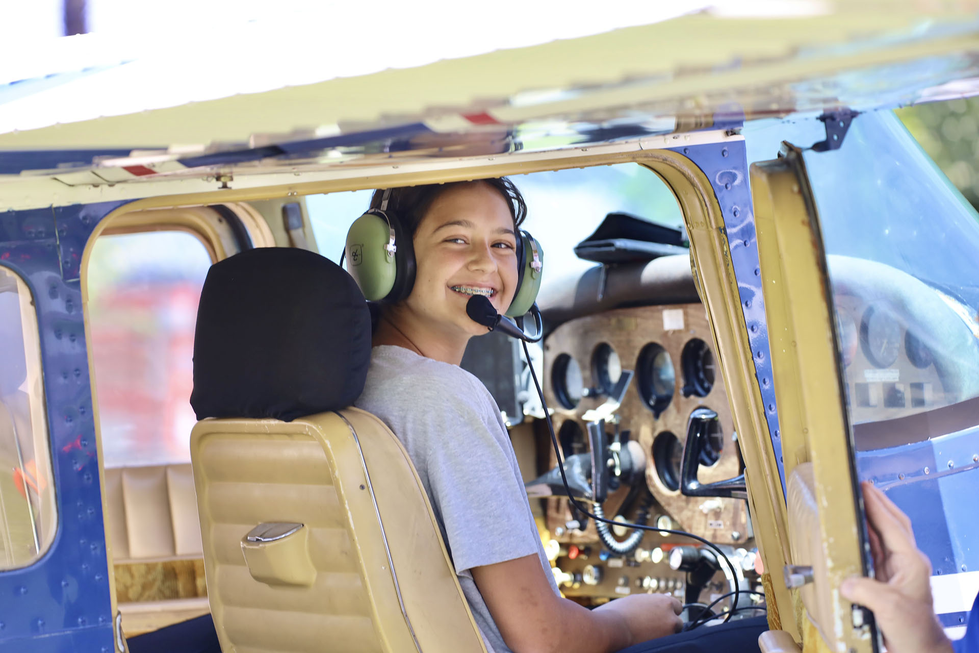 1st picture - A Cal Poly Pomona Caltrans National Summer Transportation Institute (NSTI) student smiles as she pilots a small airplane at the Flabob Airport in Riverside, CA on August 16, 2025.