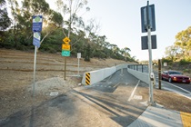 Separated, class one bike lane with signage adjacent to highway