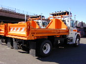 This image shows the side of a four yard dump truck from an oblique angle.