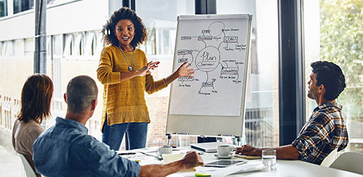 A woman giving a presentation to her team