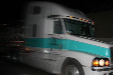 Large semi passing by in a blur.